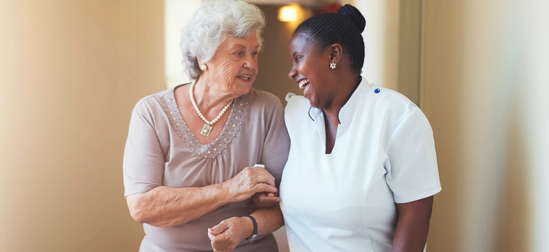 Happy female caregiver and senior woman