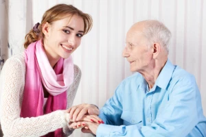 caregiver comforting senior man