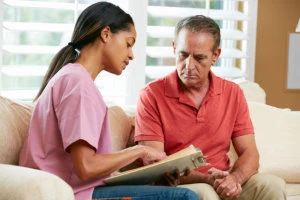 caregiver talking to the old man