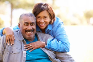 caregiver and senior man smiling