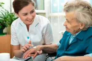 caregiver comforting old woman