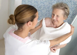 caregiver assisting old woman